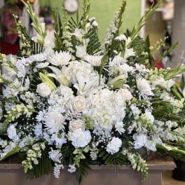 Large white floral spray with lilies, roses, and chrysanthemums
