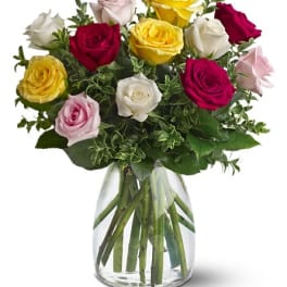 Bouquet of multicolored roses in a clear glass vase