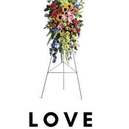 Standing floral spray with mixed flowers on an easel
