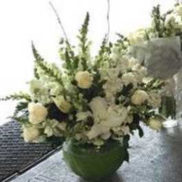 White floral arrangement in a green vase