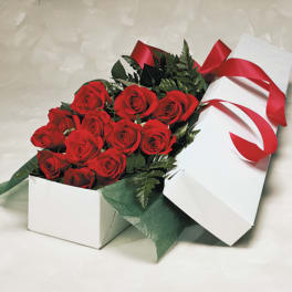 Box of red roses with a red ribbon