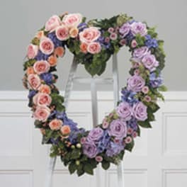 Heart-shaped floral wreath with pink, purple, and peach roses