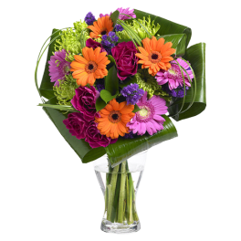 Bouquet of orange and pink flowers in a clear glass vase
