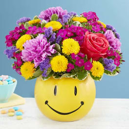 Mixed bouquet in a yellow smiley-face container