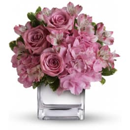 Compact pink rose, hydrangea, and alstroemeria arrangement in a clear glass cube vase