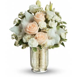 Pastel peach roses and white flowers arranged in a metallic glass vase