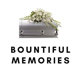 White floral spray on a silver casket