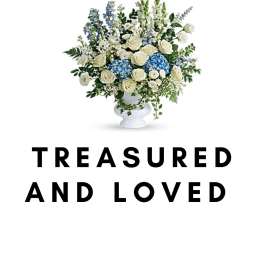White and blue floral arrangement in a white vase with memorial text below