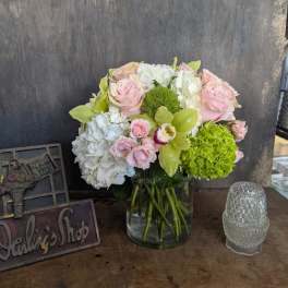 Pink and white flower arrangement in a glass vase