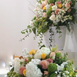 Large pastel floral arrangement in a white container