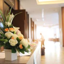 White and peach floral arrangement in a square vase