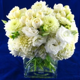 White and pale yellow bouquet in a clear glass vase