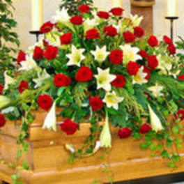 Large red and white floral casket spray with lilies and roses