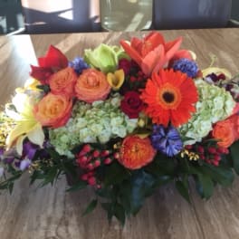 Colorful mixed flower arrangement with gerbera daisies, roses, and lilies