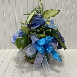 Blue floral basket with a baby boy pick and ribbon bow