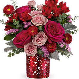 Red and pink rose bouquet in a red heart-patterned vase