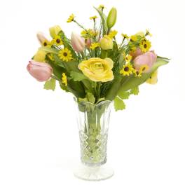 Yellow and pink tulips with small yellow daisies in a clear glass vase