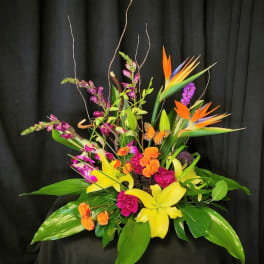 Tropical floral arrangement with orchids, lilies, and bird of paradise