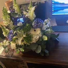 Mixed bouquet with white lilies, blue hydrangea, and white daisies