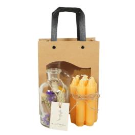 Gift bag with a glass bottle of dried flowers and a bundle of orange candles