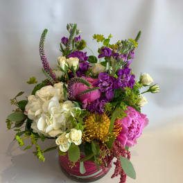 Mixed bouquet in a glass vase with white, pink, and purple flowers