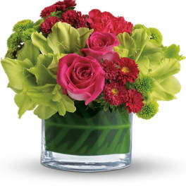 Pink roses and red chrysanthemums in a clear glass vase