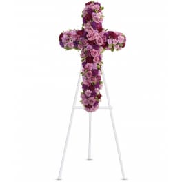 Purple and pink floral cross on a white easel