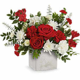 Red roses and white daisies in a square vase