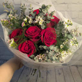 Bouquet of red roses with white filler flowers and eucalyptus