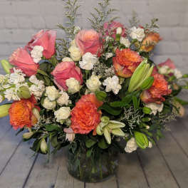 Pink and orange mixed bouquet in a glass vase