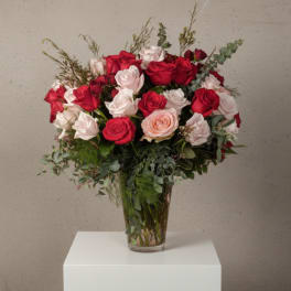 Bouquet of red and white roses in a clear glass vase