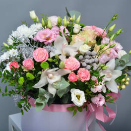 Pink and white mixed bouquet in a round box with a pink ribbon