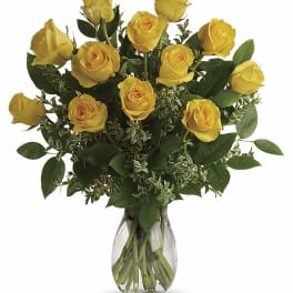 Yellow roses arranged in a clear glass vase