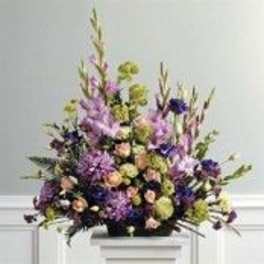 Tall mixed bouquet with purple, peach, and green flowers