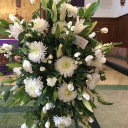 Large white floral standing spray with lilies and chrysanthemums