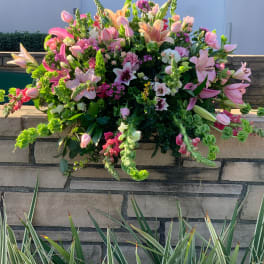 Large pink and peach floral arrangement with lilies and snapdragons