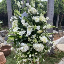 Tall white floral standing spray with lilies and hydrangeas
