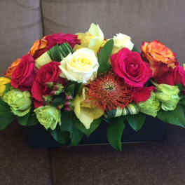 Mixed roses in a low rectangular arrangement