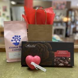 Gift set with coffee, chocolates, and a heart-shaped rose tag