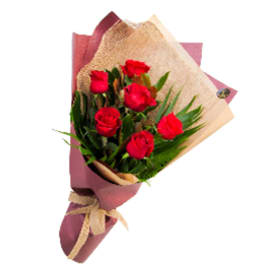 Bouquet of red roses wrapped in pink and tan paper