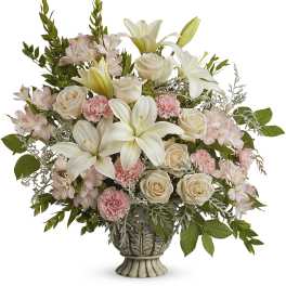 Cream roses, white lilies, and pink alstroemeria in a decorative vase