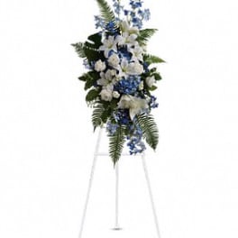Tall blue and white floral standing spray on a metal easel