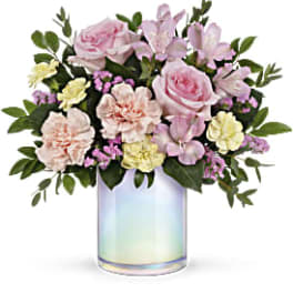 Pink and cream flower arrangement in an iridescent glass vase