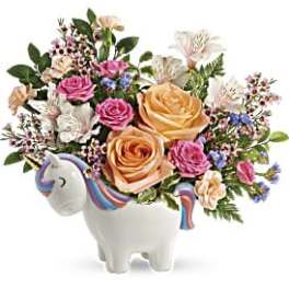 Bouquet of roses and mixed flowers in a unicorn-shaped vase
