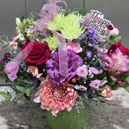 Mixed bouquet in a green vase with a Happy Mother's Day sign