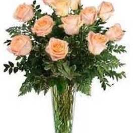 Peach roses arranged in a clear glass vase