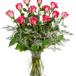 Pink-tipped roses arranged in a clear glass vase