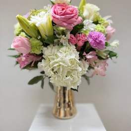 Pink and white bouquet in a gold vase