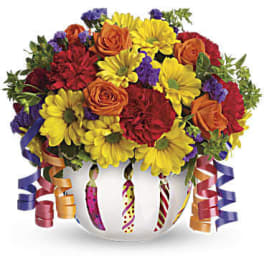 Colorful bouquet of roses and daisies in a white vase with curling ribbons