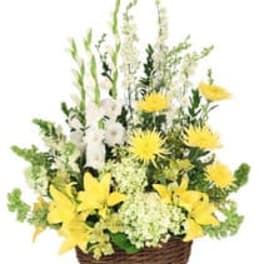 Yellow and white floral arrangement in a wicker basket
